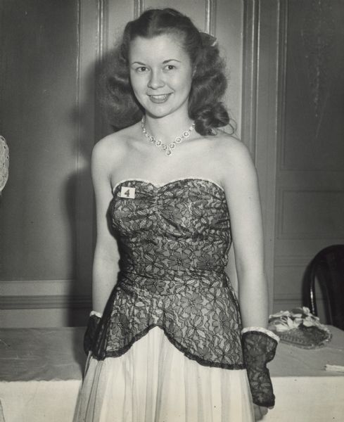 Three-quarter length portrait of Margaret McGuire at the Schraeder Hotel in Milwaukee on the night of the Alice in Dairyland contest.