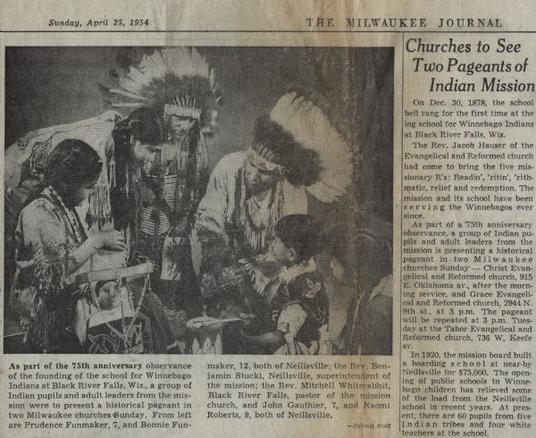 Winnebago children and adults are dressed in traditional clothing for the photo. The caption reads: "As part of the 75th anniversary observance of the founding of the school for Winnebago Indians at Black River Falls, Wis., a group of Indian pupils and adult leaders from the mission were to present a historical pageant in two Milwaukee churches Sunday. From left are Prudence Funmaker, 7, and Bonnie Funmaker, 12, both of Neillsville; the Reverend Benjamin Stucki, Neillsville, superintendent of the mission; the Rev. Mitchell Whiterabbit, Black River Falls, pastor of the mission church, and John Gauthier, 7, and Naomi Roberts, 9, both of Neillsville."