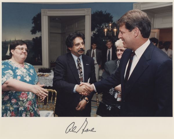 Mayor Paul Soglin shaking hands with Vice President Al Gore at the White House. At the bottom is Al Gore's autograph.