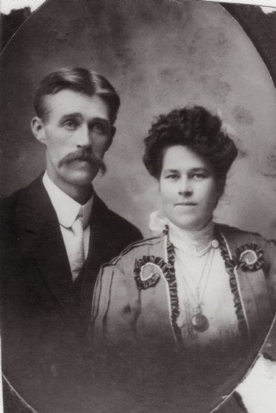 Formal waist-up wedding portrait of Carl and Christine Peterson.