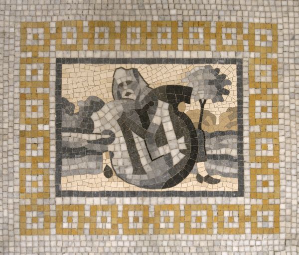 Mosaic in the south/central lobby floor of the Wisconsin Historical Society. The printer's mark of Melchor Lotter, a Leipzig printer from 1491-1536, was inspired by the meaning of his name. "LOTTER" is an old German name for vagabond, and the design represents a beggar in a suppliant position.

The printer’s mark of Melchior Lotter displayed in the Vassar Library consists of the initials M.L. Lotter used a more elaborate device in many of his publications; it depicts a mendicant holding a shield bearing his monogram. This could be an illustration of the colloquial translation of Lotter, meaning “vagabond.”