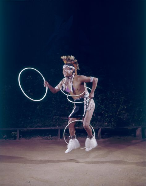 Tony White Cloud performs a Hoop Dance at the Stand Rock Indian Ceremonial. He is dressed in Native American ceremonial clothing.<p>During its 78-year run (1919 to 1997) the Stand Rock Indian Ceremonial provided viewers a small glimpse into the ceremonies and dances performed by the Winnebago, Sioux, Kiowa and southwestern Native American tribes.</p>