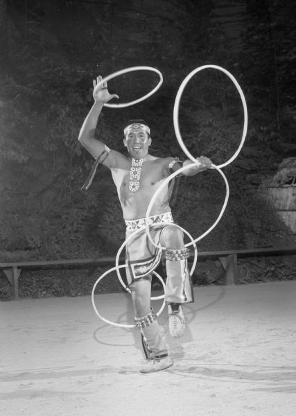 Spencer Lone Tree performing a Hoop Dance at the Stand Rock Indian Ceremonial. He is dressed in Native American ceremonial clothing.<p>During its 78-year run (1919 to 1997) the Stand Rock Indian Ceremonial provided viewers a small glimpse into the ceremonies and dances performed by the Winnebago, Sioux, Kiowa and southwestern Native American tribes.</p>