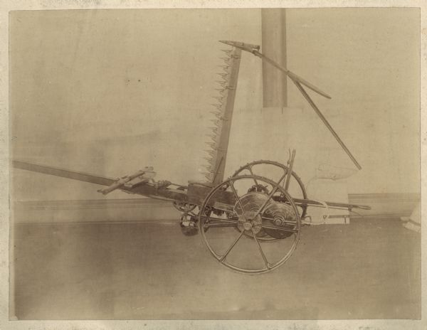 Side view of a McCormick Harvesting Machinery mower.  Contextual clues suggest this may be a McCormick no.4 mower.