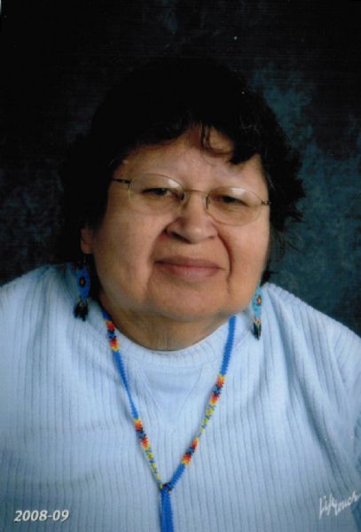 Quarter-length, formal portrait of Frances Oiyotte Decorah, one of the "Five Sisters" and an elder on the St. Croix Ojibwe Reservation.