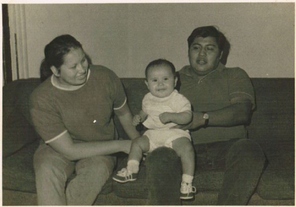 Informal family portrait of Frances (mother), Patrick (son) and Stuart Decorah (father), seated on a sofa.