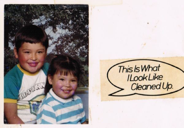 Commercial portrait of two children, likely siblings. An outdoor scene is in the background. On the card is a sticker that reads: "This Is What I Look Like Cleaned Up."