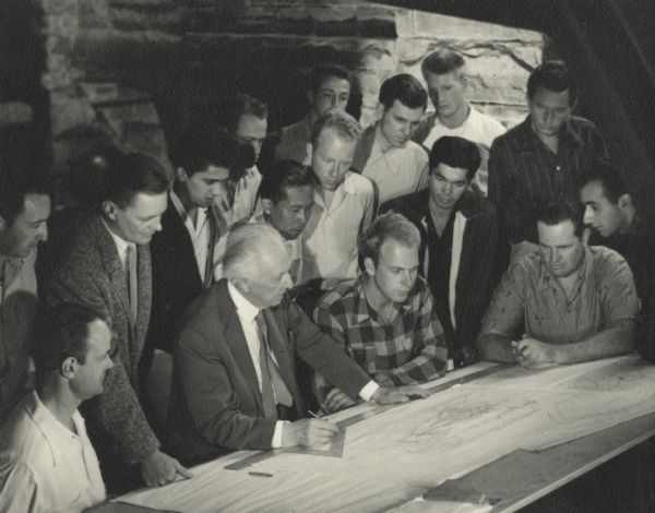 Frank Lloyd Wright with apprentices at Taliesin. Eric Lloyd Wright is seated to the right of FLW. Taliesin is located south of Spring Green, on the opposite side of the river.