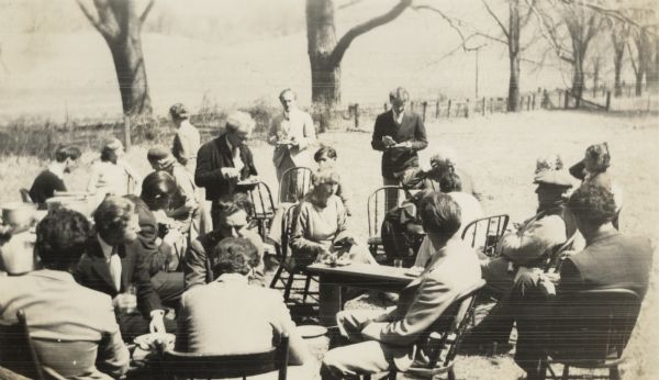A group of people gathered for an outdoor lunch.