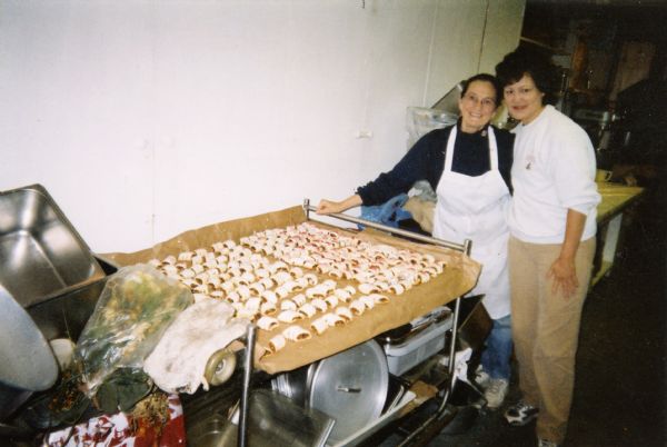 Joanne Schuepbach Jensen and Donna Dirienzo Skoug standing with the handmade Italian cookies (cuccidati) at Josie's Restaurant, 906 Regent Street.