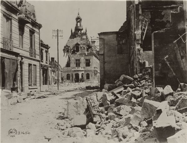 Street in Fismes, France destroyed during the Battle of Fismes. The badly damaged town hall can be seen near the center, with rubble from other buildings in the foreground.