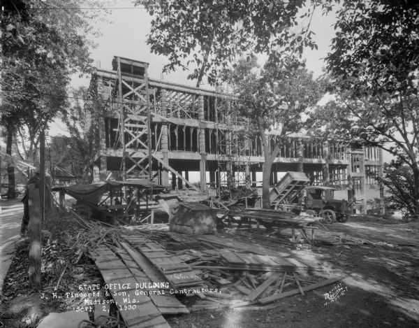 State Office Building, 1 W. Wilson Street, under construction. Side view, with Castle & Doyle dump truck.