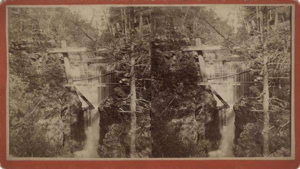 Elevated view stereograph of the dam at Pewit's Nest on Skillet Creek. Caption on reverse reads: "Devil's Lake and Wisconsin Scenery."