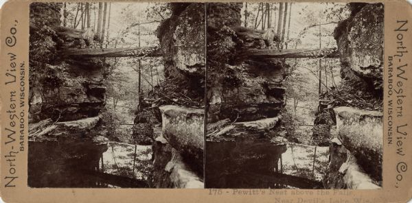 Stereograph of a view of Pewit's Nest from above the dam. Caption at foot: "175 — Pewit's Nest above the Falls, Near Devil's Lake, Wis."
