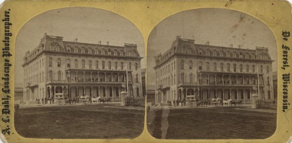 Stereograph of the Park Hotel on the corner of Main and Carroll Streets. The Park Hotel wagon and baggage wagon are in front of the hotel. People are in front of the building and on the second floor balcony.