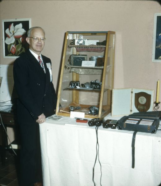 Seton Rochwite, designer of the Stereo-Realist Camera, with his handmade forerunners of the Realist. Display at the Photographic Society of America Convention in Denver.
