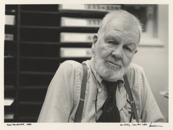 Casual portrait of Paul Vanderbilt taken in his Emeritus office at the Wisconsin Historical Society. He was the Curator of the Iconographic Collections from 1954 to 1972. Paul Vanderbilt considered this his official portrait. Caption handwritten at the bottom reads: "Paul Vanderbilt, 1986" and "for Andy, into the light. Lewis Koch."