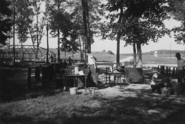 Lewis Arms and other men preparing chow outdoors at an Army post at Fort Knox. 