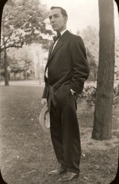 &#65279;Harry Lynde Bradley posing in a suit, outdoors. He is holding a hat in his right hand.