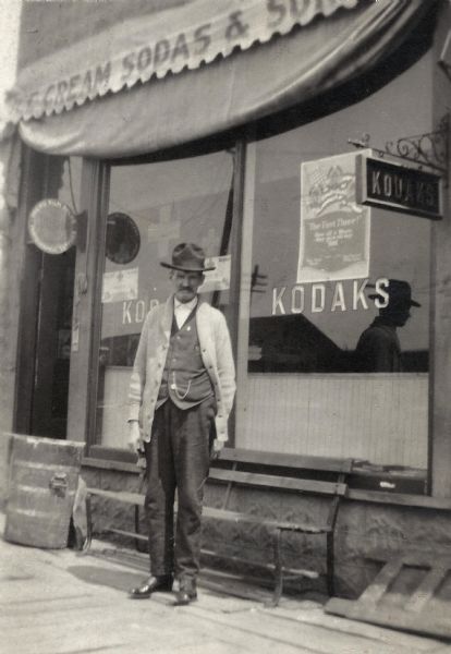 Jerome Francis Franklin Sr. poses in front of the family Drug Store and Eland Post Office. He was postmaster in Eland for many years on and off, also Justice of the Peace. At this time he was listed as: Postmaster, Real Estate, Insurance, and Loans.