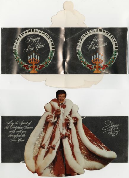 Custom holiday card for the entertainer Liberace. On the outside front and back are two wreaths of piano keys, with holly, ribbons and his signature candelabra. The front reads: "Merry Christmas" and the back reads: "Happy New Year." When the card is opened, a die cut photographic image of Liberace folds out. He is standing and holding a microphone and is wearing a red and white coat under a red cape with white fur trim. The text reads: "May the Spirit of this Christmas Season abide with you throughout the New Year." Four color offset lithography over opaque white ink on silver metallic cover stock.