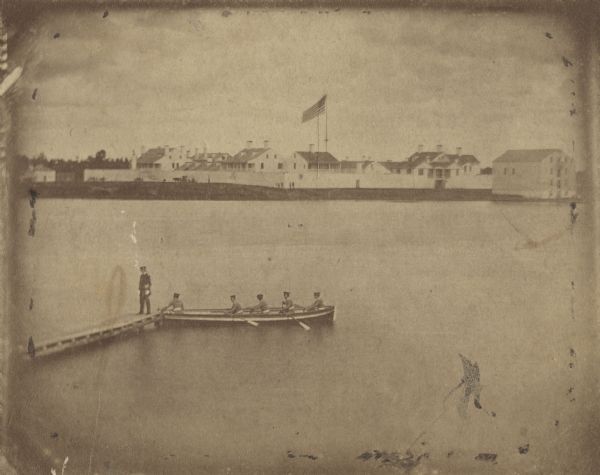 A rare photograph of U.S. Army soldiers stationed at Fort Howard rowing a boat on the Fox River. Fort Howard, built in 1816, was the first in the chain of forts stretching from Fort Winnebago (at Portage) and Fort Crawford at Prairie du Chien in order to protect the early Wisconsin frontier. Because of unhealthy conditions a new fort was built on higher ground. Two years after this photograph was taken, the Fort Howard was decommissioned. Several of its original buildings have been preserved at Heritage Hill State Historical Park.