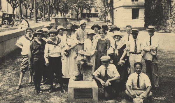 Group portrait of Charles Brown (center with the white hat) and his University of Wisconsin students before setting out on a summer session excursion. Judge E.T. Fairchild is on the far right. The group is gathered around the Spirit Stone at the corner of State and Park Streets, and the plaque reads: "Wisconsin Potawatomi Indians, formerly at 'Big Stone.' Forest County, Marked by Landmarks Committee WHS. January 24, 1922."