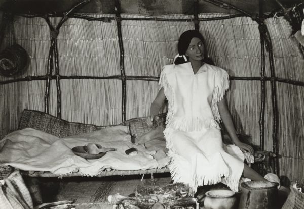 A recreation of an Indian hut with a mannequin exhibited in the galleries at the State Historical Society of Wisconsin.