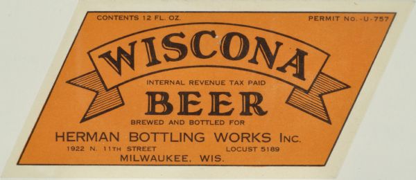 Label submitted to the state of Wisconsin for trademark registration. The label is cut in the shape of a parallelogram. "Wiscona Beer, Herman Bottling Works Inc., 1922 N. 11th Street." The label is orange and Wiscona is written across a simple banner.