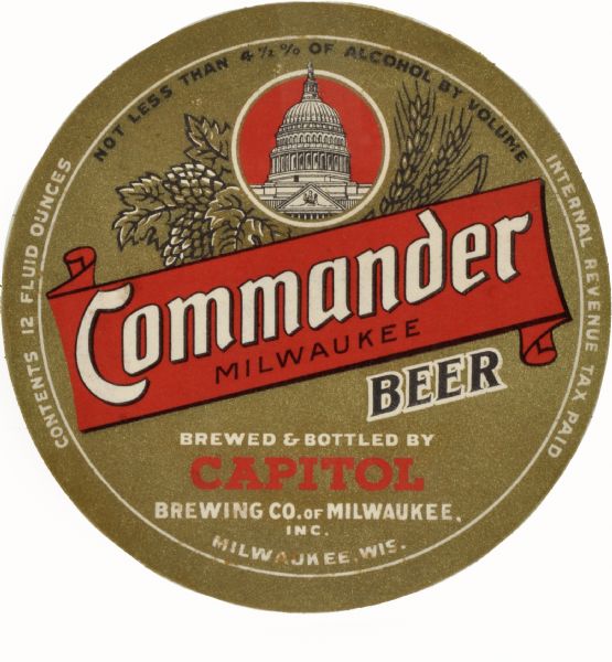 Label submitted to the state of Wisconsin for trademark registration. "Commander Beer, Milwaukee, Brewed and Bottled by Capitol Brewing company of Milwaukee" the round label includes an inset image of a capitol building. Near a banner with the script of the label are images of grain plants and hops.