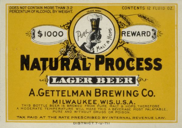 Label submitted to the State of Wisconsin for trademark registration. "$1000 Reward, Pure Malt & Hops, Natural Process, Lager Beer, A. Gettelman Brewing Co." The center of the label is an inset image of a hand holding a glass of beer, with hop plants and stalks of wheat or barley surrounding the trademark.