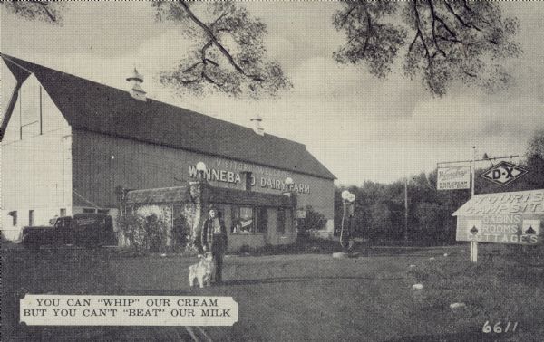 Postcard submitted to the state of Wisconsin for trademark registration. On the front of the postcard is the slogan: You can 'whip' our cream but you can't 'beat' our milk." A man stands with a dog on a road in front of a storefront with gas pumps. In the background is a large barn.
