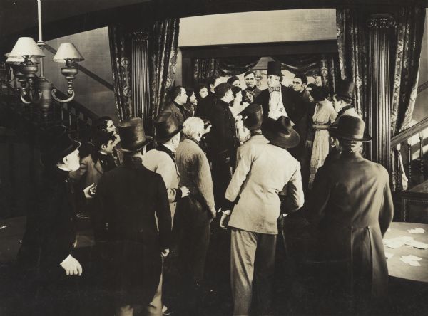 Film still of a group of people, interior.