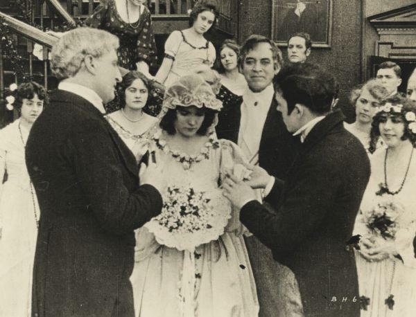 Film still of a wedding.
 	