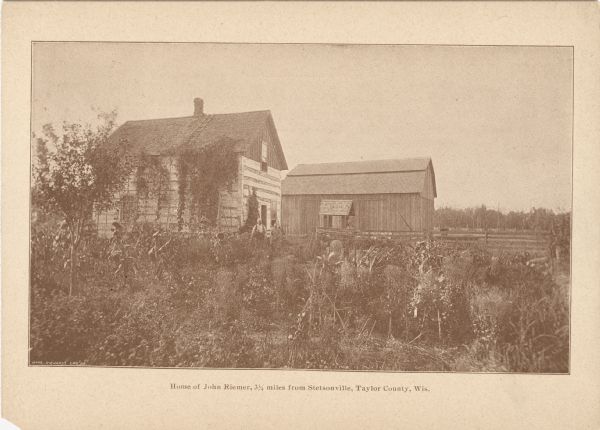 Promotional card displaying John Riemer and a women in front his home. 
<p>The caption reads, "Home of John Riemer, 3.75 miles from Stetsonville, Taylor County, Wis."</p>