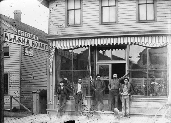 Five men standing outside the Conrad Meyer Alaska House saloon and hotel. The building was located at 416 North 9th Street.