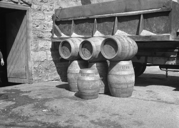 Seven beer barrels stacked in front of a truck, outside the Potosi Brewery.