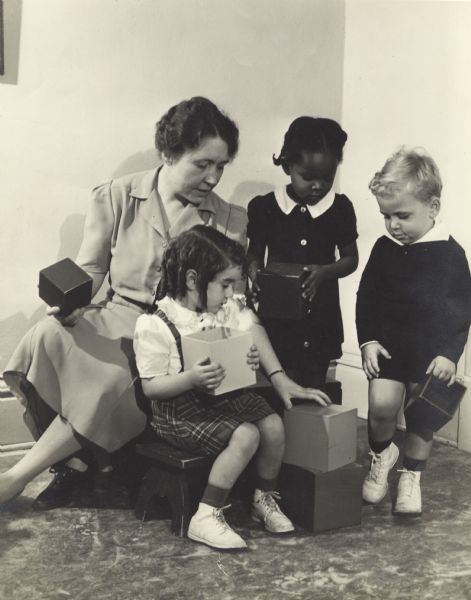 Mary Lee Griggs, head of Parent Education and director of the Play School at Neighborhood House, with Catherine Oliva, Delores Caire, and Sam Moskowsky. The settlement house was located at 768 W. Washington Avenue.