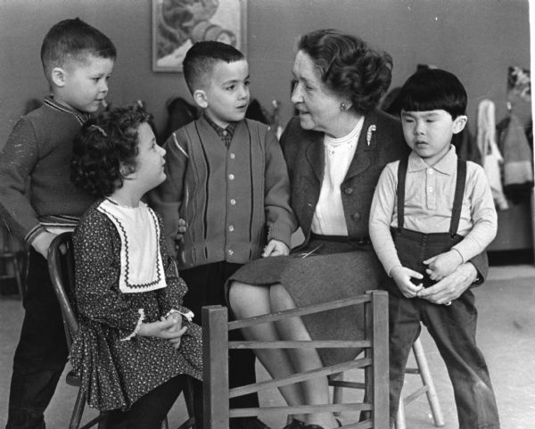 Mary Lee Griggs, director of the Play School at Neighborhood House, with Elizabeth Schuch, Joseph Oliva, Joseph Pelitteri, and Yoshi Goto. Two of these children were the offspring of students who had also attended the Play School as children decades before. Neighborhood House was located at 29 South Mills Street.