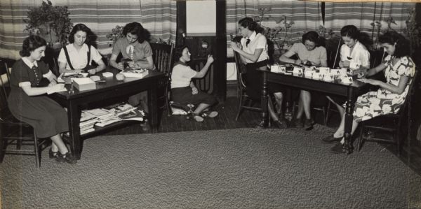 Gamma Delta Club members working on a card-making project and listening to the radio. The club was one of many sponsored by Neighborhood House.