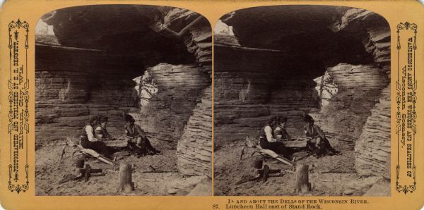Three people and a young child sitting around a stone table in Luncheon Hall. Text at right: "Wanderings Among the Wonders and Beauties of Wisconsin Scenery."