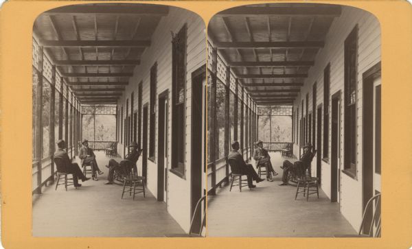 Stereograph of three men sitting on a porch of Larks Hotel.