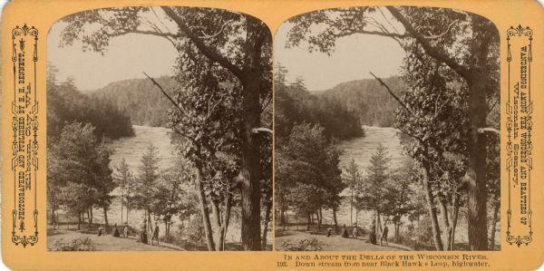 Elevated view from hill towards five people standing on a hillside, facing the water. Text at right: "Wanderings Among the Wonders and Beauties of Wisconsin Scenery."