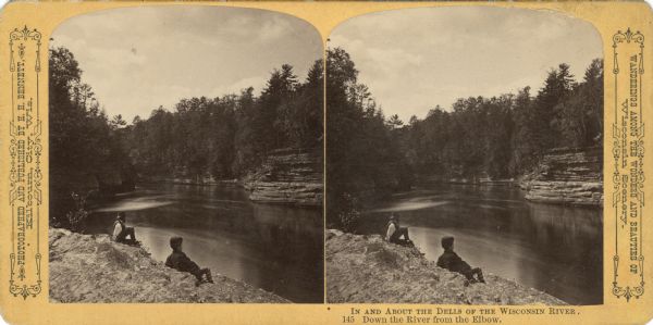 A man and a boy sitting on a rock formation at Devil's Elbow. Text at right: "Wanderings Among the Wonders and Beauties of Wisconsin Scenery."