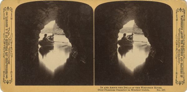 Looking through a cave towards two men in a rowboat. Text at right: "Wanderings Among the Wonders and Beauties of Wisconsin Scenery."