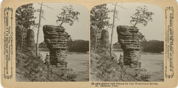 Ruth Bennett and Miriam Bennett holding hands while facing Chimney Rock. High Rock is in the distance. Text at right: "Wanderings Among the Wonders and Beauties of Wisconsin Scenery."
