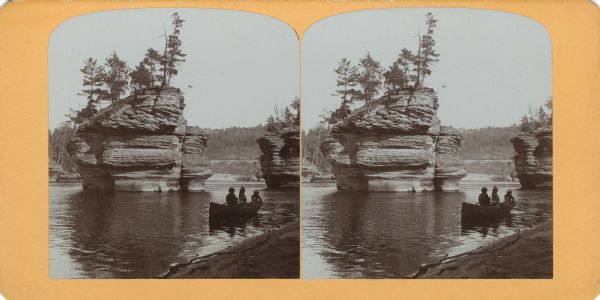 View from shoreline of three people, probably children, on a rowboat near the north side of Sugar Bowl.