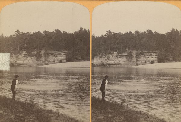 An unidentified man skipping stones across the Wisconsin River.