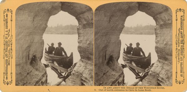 View from inside of cave of two men in a canoe in the river at the entrance to the cave. Text at right: "Wanderings Among the Wonders and Beauties of Wisconsin Scenery."