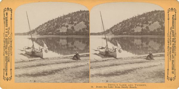 View from shoreline at Devil's Lake of a boy standing in the shallow water leaning against a sailboat. A young girl wearing a hat is sitting on the sandy beach nearby. Text at right: "Wanderings Among the Wonders and Beauties of Wisconsin Scenery."